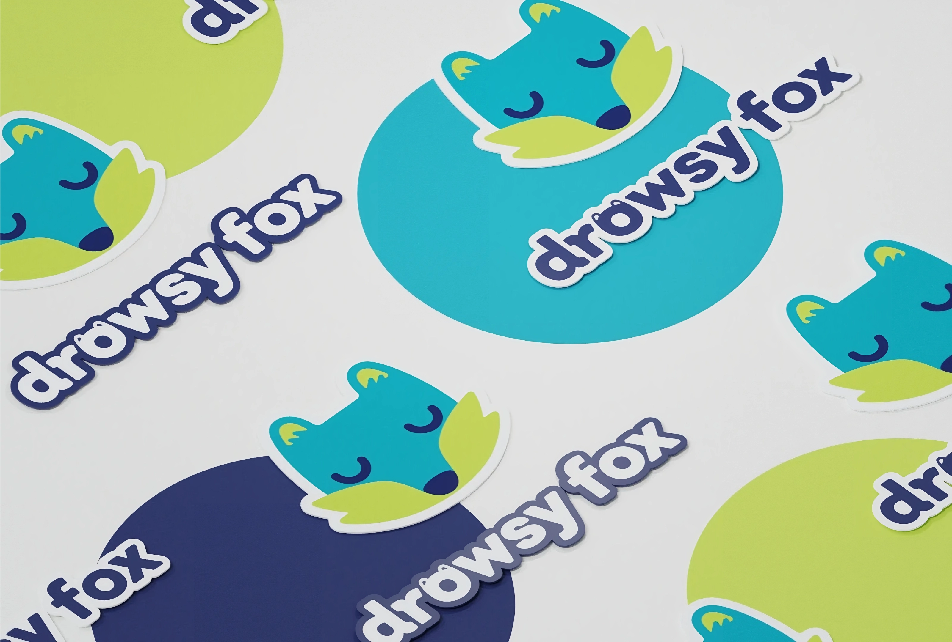 stickers featuring the drowsy fox logo and its logotype 